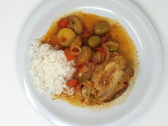 Cuban chicken fricassee with potatoes, vegetables and rice