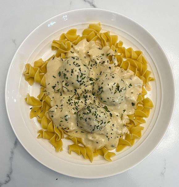 Creamy meatballs stroganoff over noodles